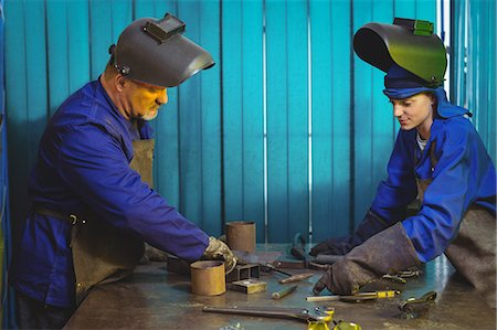 simsearch:6109-08722895,k - Male and female welders working together in workshop Stock Photo - Premium Royalty-Free, Code: 6109-08722904