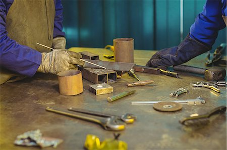 simsearch:6109-08722895,k - Mid-section of male and female welders working together in workshop Stock Photo - Premium Royalty-Free, Code: 6109-08722905
