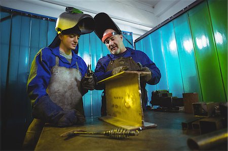 simsearch:6109-08722895,k - Male and female welders working together in workshop Stock Photo - Premium Royalty-Free, Code: 6109-08722910