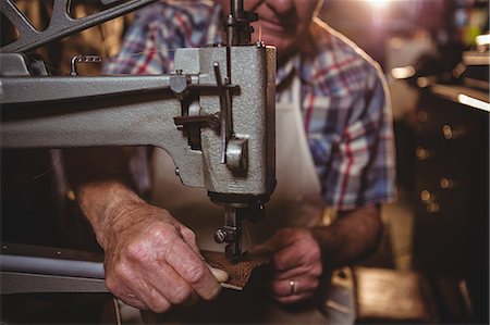 shoes store old age - Shoemaker using sewing machine in workshop Stock Photo - Premium Royalty-Free, Code: 6109-08722920