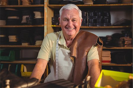 Portrait of smiling shoemaker sitting in workshop Stock Photo - Premium Royalty-Free, Code: 6109-08723002