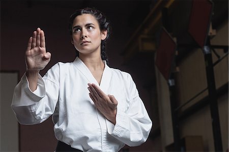 simsearch:6109-08739250,k - Woman practicing karate in fitness studio Stock Photo - Premium Royalty-Free, Code: 6109-08739244