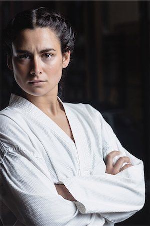 Portrait of woman standing with arm crossed in fitness studio Stock Photo - Premium Royalty-Free, Code: 6109-08739246