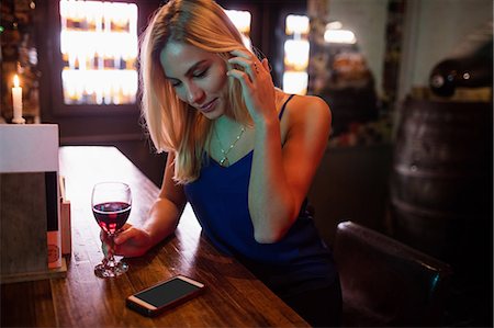 simsearch:6109-08944487,k - Woman having a glass of red wine in bar Photographie de stock - Premium Libres de Droits, Code: 6109-08802002