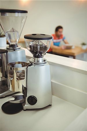 Close-up of coffee grinding equipment kept on table Stock Photo - Premium Royalty-Free, Code: 6109-08802027