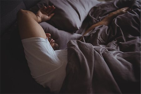 Man sleeping in his bed in bedroom at home Stock Photo - Premium Royalty-Free, Code: 6109-08802280