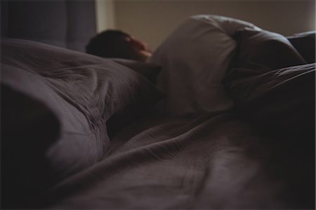 simsearch:6109-07497306,k - Rear view of man sleeping in his bed in bedroom at home Stock Photo - Premium Royalty-Free, Code: 6109-08802281