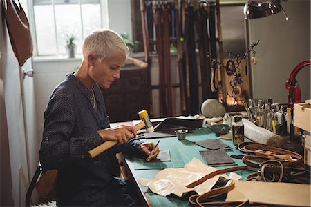 simsearch:614-08821252,k - Craftswoman hammering leather in workshop Stock Photo - Premium Royalty-Free, Code: 6109-08802344