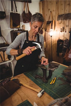 simsearch:614-08821252,k - Craftswoman hammering leather in workshop Stock Photo - Premium Royalty-Free, Code: 6109-08802361