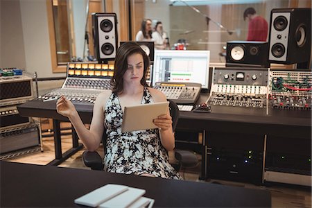 recording studio connecting - Audio engineer using digital tablet in music studio Stock Photo - Premium Royalty-Free, Code: 6109-08802378