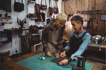 simsearch:614-08821252,k - Craftswomen discussing over a piece of leather in workshop Stock Photo - Premium Royalty-Free, Code: 6109-08802312