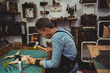 simsearch:649-07905510,k - Craftswoman hammering leather in workshop Stock Photo - Premium Royalty-Free, Code: 6109-08802319