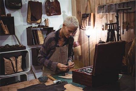 simsearch:614-08821252,k - Craftswoman working on a piece of leather in workshop Stock Photo - Premium Royalty-Free, Code: 6109-08802320