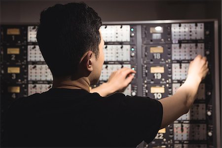 simsearch:6109-08953686,k - Rear view of audio engineer using track recorder in recording studio Stock Photo - Premium Royalty-Free, Code: 6109-08802416