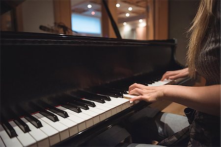simsearch:6109-08764998,k - Mid section of woman playing a piano in music studio Stock Photo - Premium Royalty-Free, Code: 6109-08802432