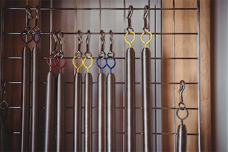 Various exercise equipment hanging on frame in fitness studio Stock Photo - Premium Royalty-Free, Code: 6109-08802579