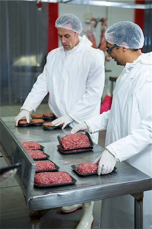 processed meat - Two butchers packaging minced meat at a meat factory Stock Photo - Premium Royalty-Free, Code: 6109-08802964