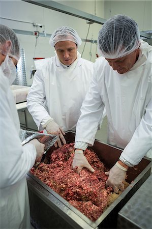 processing - Attentive butchers mixing minced meat in meat factory Stock Photo - Premium Royalty-Free, Code: 6109-08803007