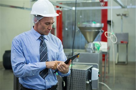 simsearch:6109-08782991,k - Attentive technician using digital tablet at meat factory Stock Photo - Premium Royalty-Free, Code: 6109-08803004
