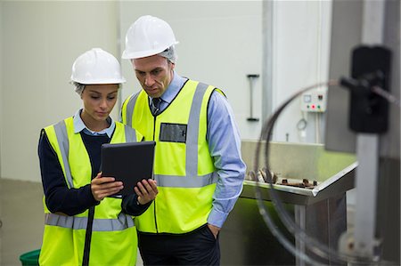 Two technician discussing over digital tablet at meat factory Stock Photo - Premium Royalty-Free, Code: 6109-08803006