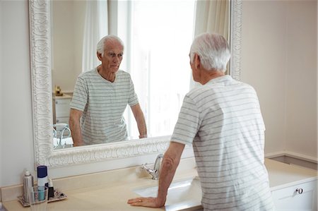 simsearch:6109-08435535,k - Senior man looking at mirror in bathroom Stock Photo - Premium Royalty-Free, Code: 6109-08803147
