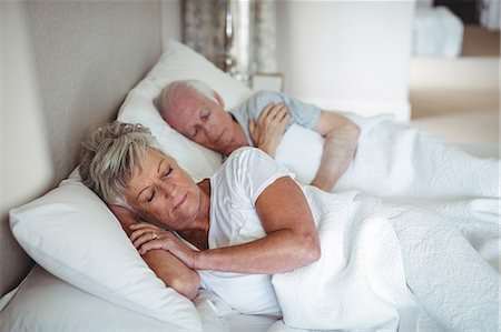 simsearch:6109-08489144,k - Senior couple sleeping on bed in bedroom Stock Photo - Premium Royalty-Free, Code: 6109-08803175