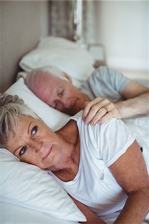 simsearch:6109-06781886,k - Senior couple lying on bed in bedroom Stock Photo - Premium Royalty-Free, Code: 6109-08803180