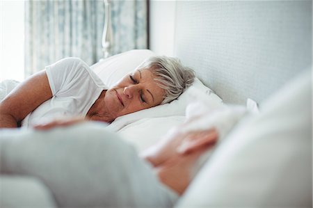 simsearch:6109-06781886,k - Senior couple sleeping on bed in bedroom Stock Photo - Premium Royalty-Free, Code: 6109-08803186