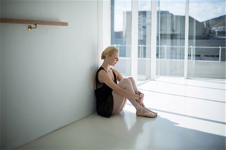 simsearch:6109-08803046,k - Depressed ballerina sitting against wall in the studio Stock Photo - Premium Royalty-Free, Code: 6109-08803100