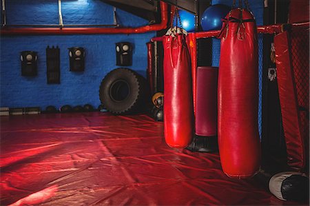 simsearch:6109-08765058,k - Red punching bags hanging on fitness studio Stock Photo - Premium Royalty-Free, Code: 6109-08803695