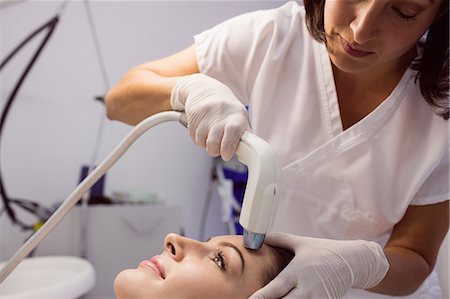 simsearch:6109-08803835,k - Doctor giving cosmetic treatment to female patient at clinic Stockbilder - Premium RF Lizenzfrei, Bildnummer: 6109-08803842