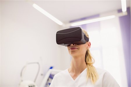 rejuvenating - Female doctor wearing virtual reality headset in clinic Stock Photo - Premium Royalty-Free, Code: 6109-08803853