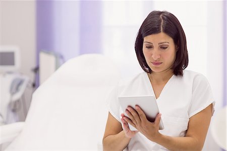 dermatologist - Dermatologist using digital tablet in clinic Stock Photo - Premium Royalty-Free, Code: 6109-08803960