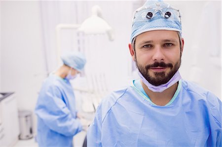 safety glasses - Portrait of dentist smiling at camera at dental clinic Stock Photo - Premium Royalty-Free, Code: 6109-08803979