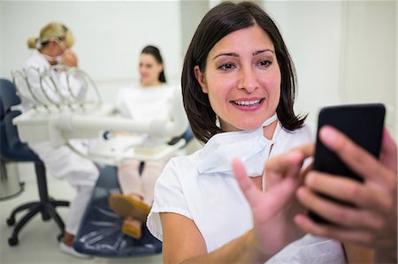 simsearch:400-04704005,k - Female doctor using mobile phone at clinic Stock Photo - Premium Royalty-Free, Code: 6109-08804057