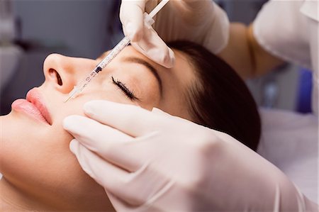 simsearch:6109-08804144,k - Female patient receiving an injection on her face in clinic Stock Photo - Premium Royalty-Free, Code: 6109-08804037