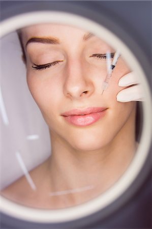 simsearch:6109-08804147,k - Female patient receiving an injection on her face in clinic Stock Photo - Premium Royalty-Free, Code: 6109-08804035