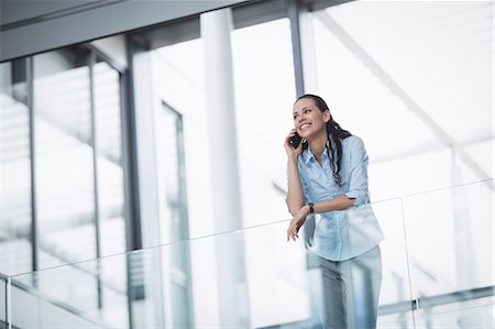 simsearch:693-08769320,k - Businesswoman talking on mobile phone inside office building Stock Photo - Premium Royalty-Free, Code: 6109-08804259