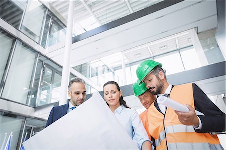 simsearch:614-06814032,k - Businessman discussing on blueprint with architects in office building Stock Photo - Premium Royalty-Free, Code: 6109-08804261