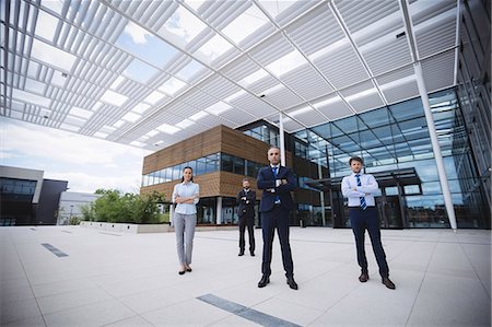 simsearch:6109-08804469,k - Group of confident businesspeople standing with arms crossed outside office building Stock Photo - Premium Royalty-Free, Code: 6109-08804269