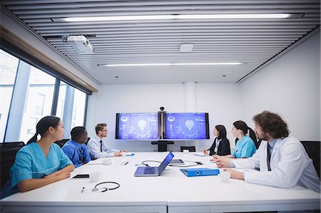 Team of doctors looking at screen in conference room at hospital Stock Photo - Premium Royalty-Free, Code: 6109-08804356
