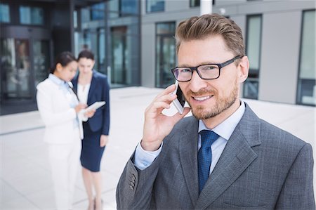 simsearch:6109-08763961,k - Confident businessman talking on mobile phone Stock Photo - Premium Royalty-Free, Code: 6109-08804307