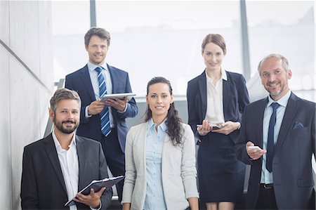 simsearch:6109-08488759,k - Portrait of confident businesspeople standing on staircase in office Stock Photo - Premium Royalty-Free, Code: 6109-08804440