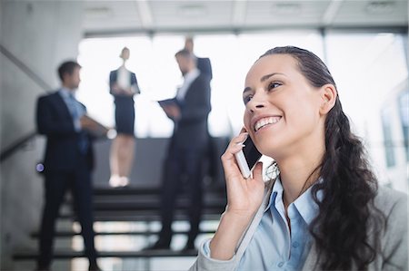 simsearch:693-08769320,k - Businesswoman talking on mobile phone in office Stock Photo - Premium Royalty-Free, Code: 6109-08804448