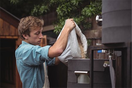 Man pouring sack of barley into wort to make beer at home brewery Stock Photo - Premium Royalty-Free, Code: 6109-08804572