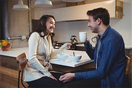 simsearch:6109-06781541,k - Couple having breakfast together in the kitchen at home Stock Photo - Premium Royalty-Free, Code: 6109-08804752