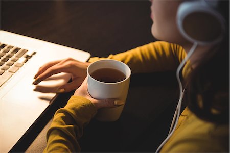 simsearch:6109-08944691,k - Woman having coffee while working on laptop in study room at home Stockbilder - Premium RF Lizenzfrei, Bildnummer: 6109-08804778