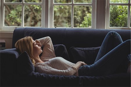 simsearch:693-07456008,k - Thoughtful woman lying on sofa in living room at home Foto de stock - Sin royalties Premium, Código: 6109-08804705