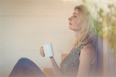 simsearch:6109-08390353,k - Thoughtful woman having coffee at home Stock Photo - Premium Royalty-Free, Code: 6109-08804713