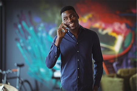 simsearch:6109-08805120,k - Businessman talking mobile phone in office Stock Photo - Premium Royalty-Free, Code: 6109-08805044